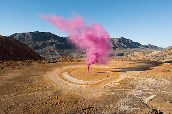 outdoor art installation with pink smoke, link to Ignant Magazine