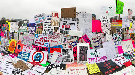 piles of signs from the Women's March